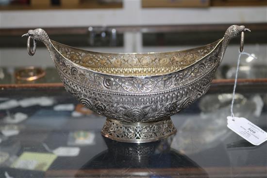 An Indian? white metal oval bowl with ring handles and three other items including two filligree items.